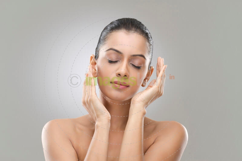 beautiful young woman protecting and caring her skin