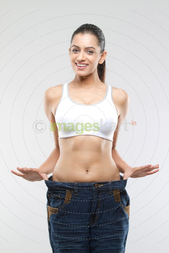 young woman smiling and streching denims