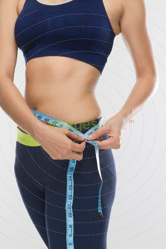 lose up of a girl measuring waist