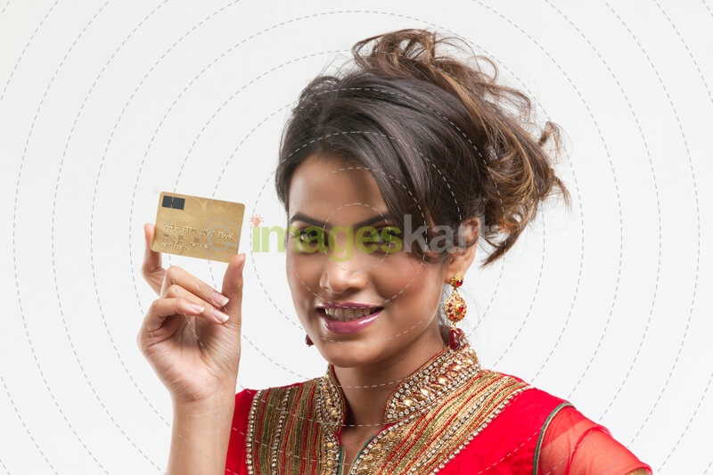 portrait of young woman holding credit card