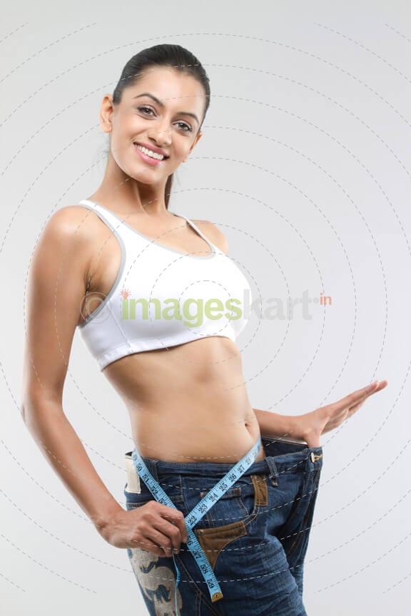 girl smiling and showing weight loss