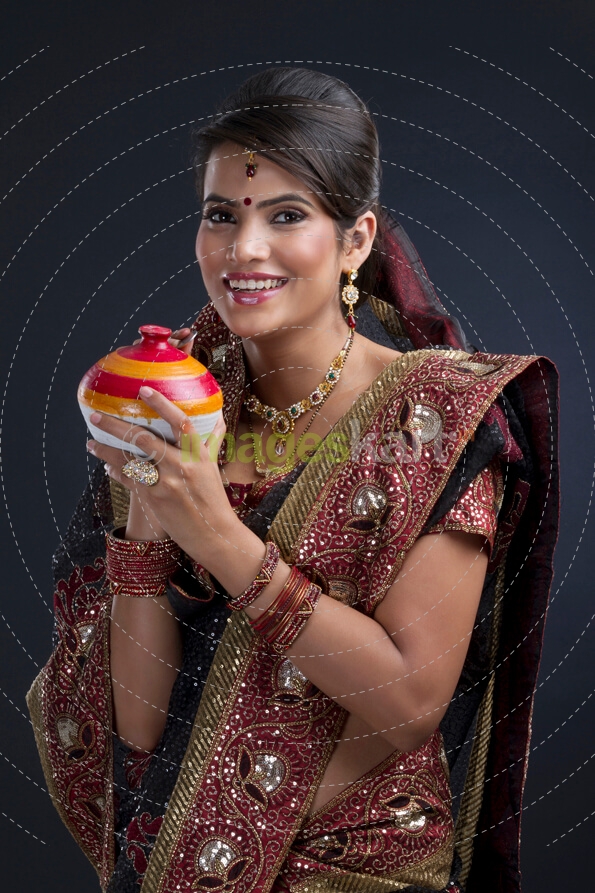 woman saving money in an Indian piggy-bank
