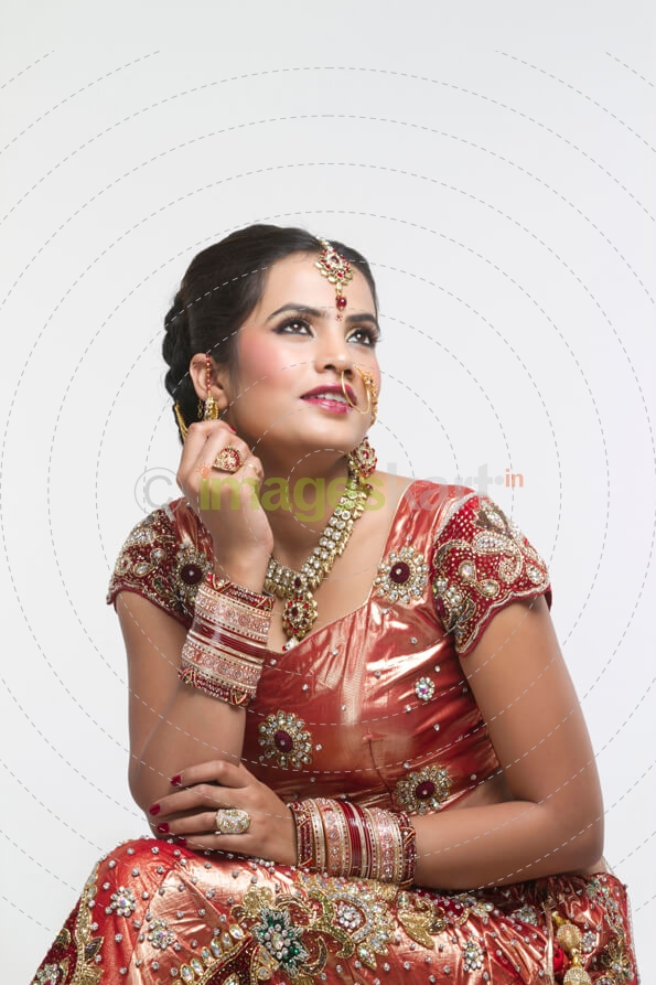 indian bride in bridal wear looking away
