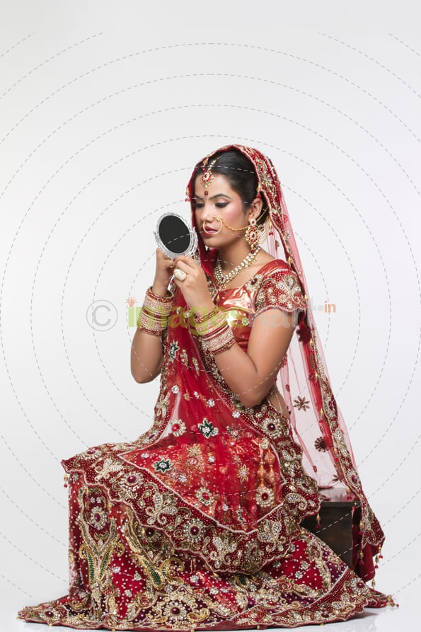 indian bride looking into the mirror 