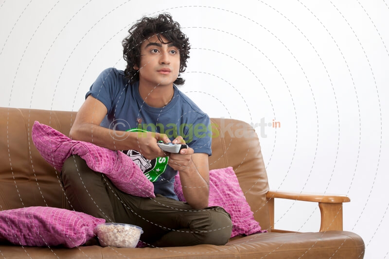 Man enjoying television with popcorn