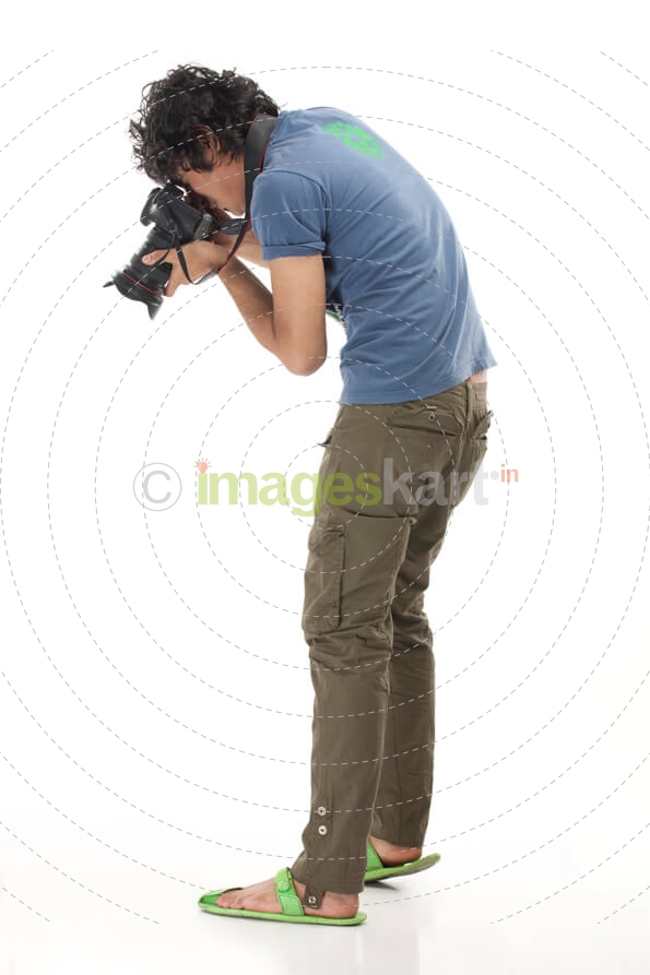 male photographer zooming at the ground