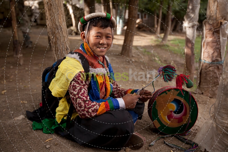 boy with ladakhi ceremonial drums