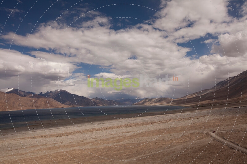 desert scenic view of high mountain and a car