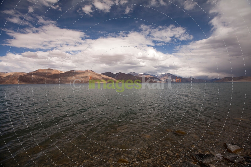 beautiful blue lake with mountains in the back