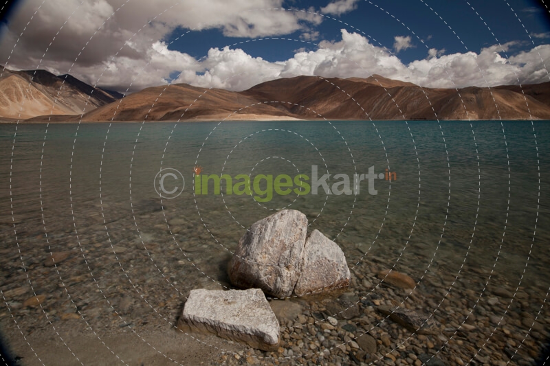 beautiful blue lake with mountains in the back