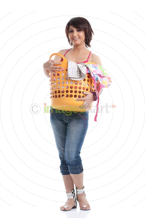 beautiful housewife holding a basket of clothes