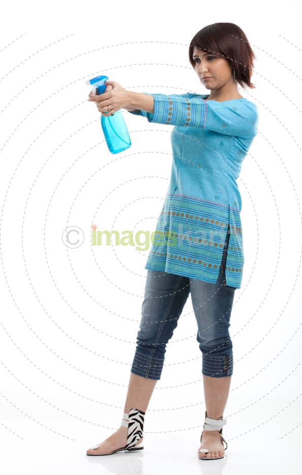 portrait of a housewife with a spray bottle in hand