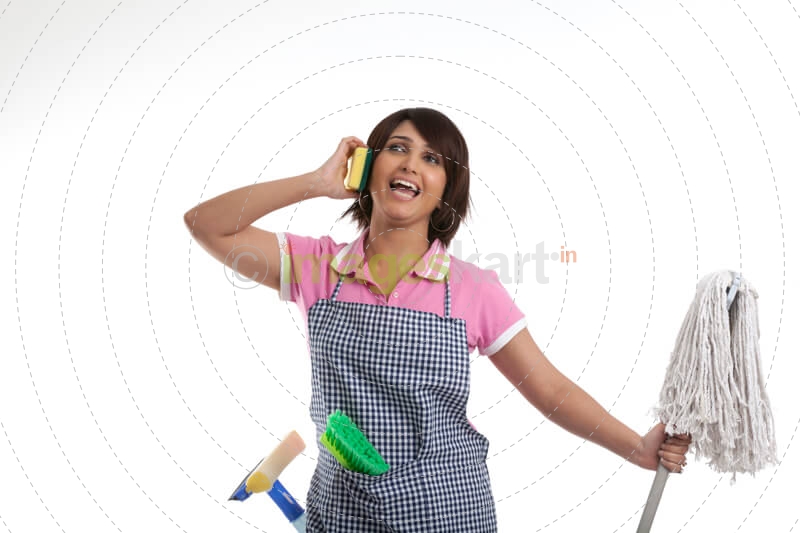 young housewife having fun while cleaning