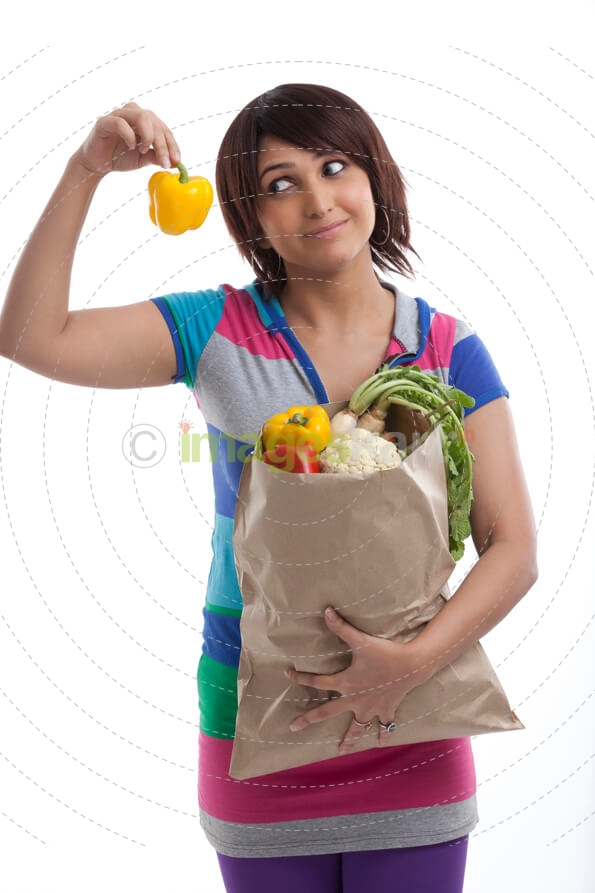 young housewife looking at capsicum