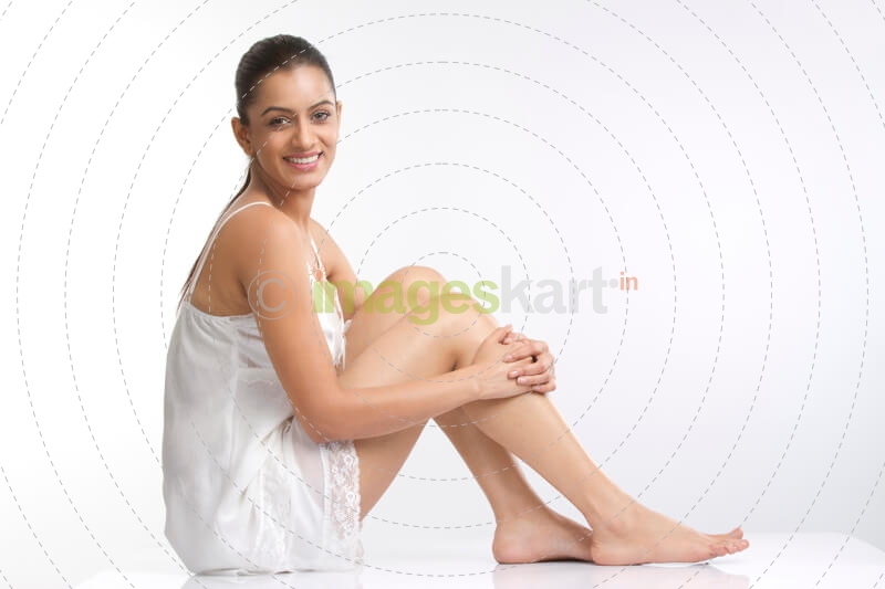 female posing in a white short dress