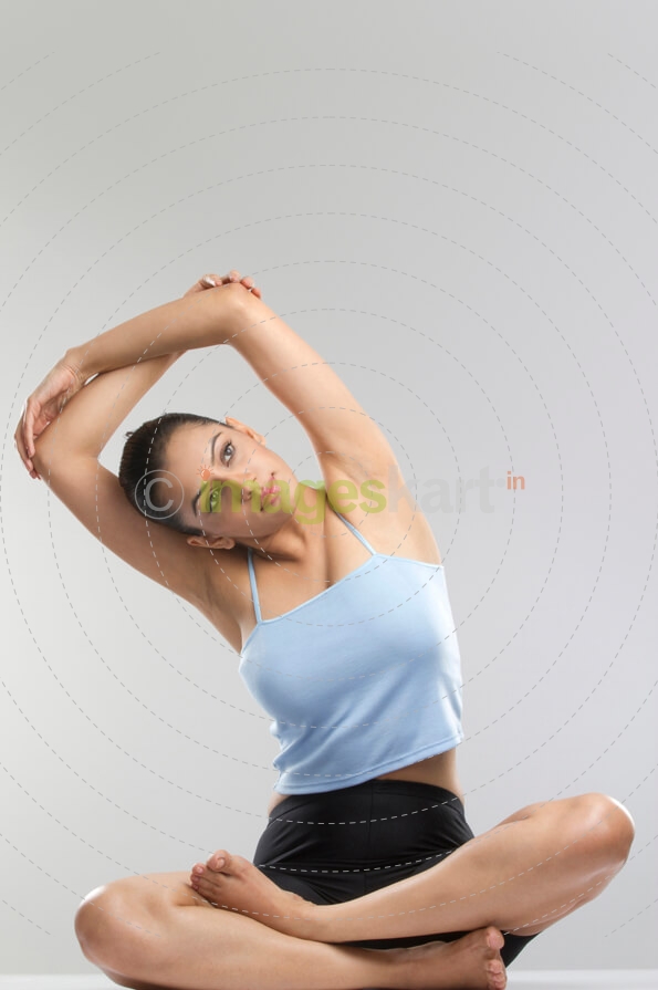 girl sitting on the floor stretching her arms
