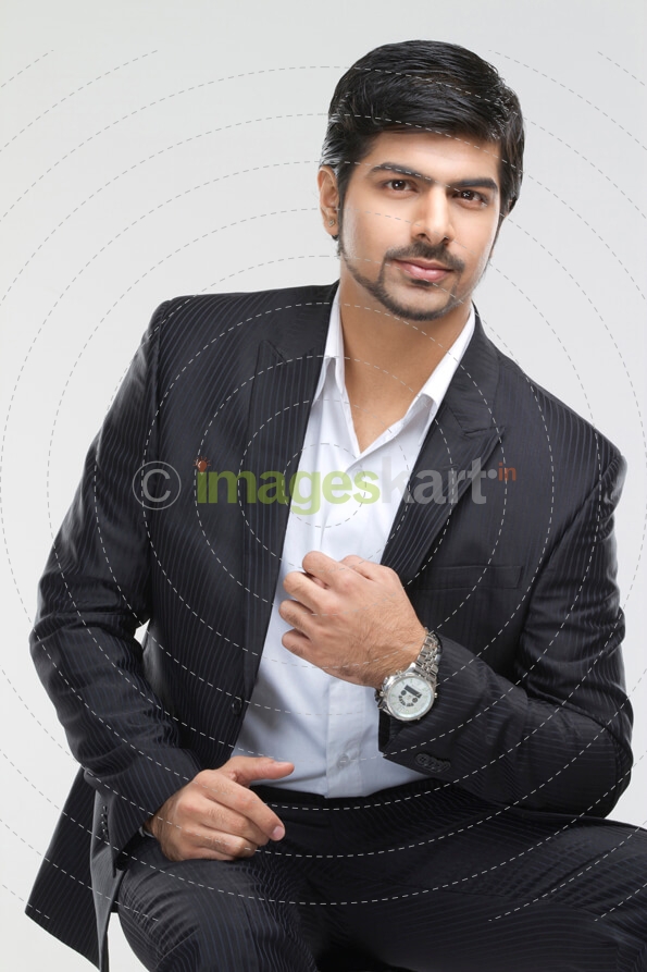 elegant gentleman posing in a suit and expensive watch