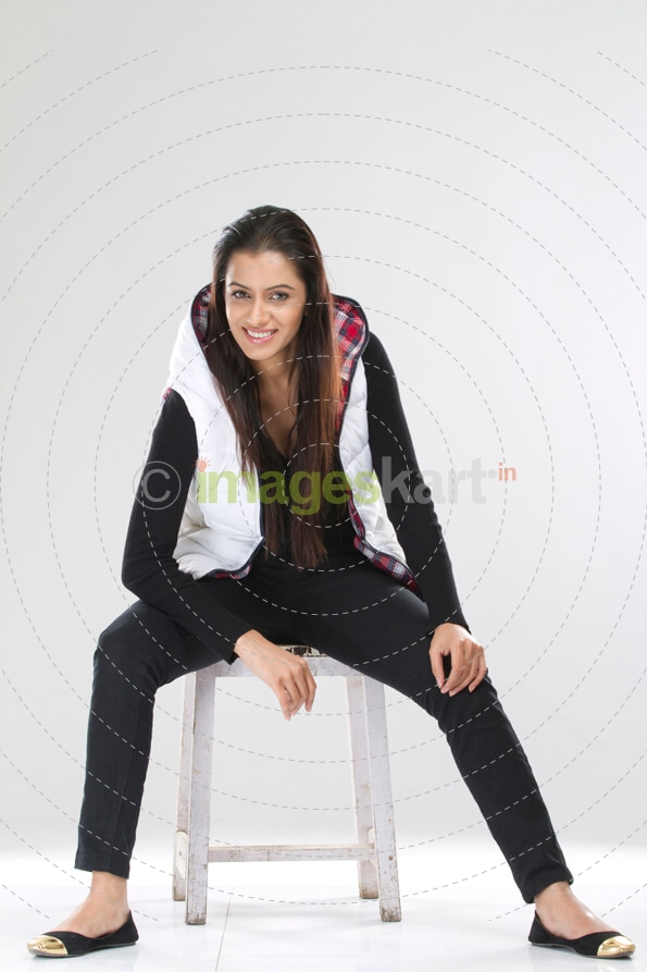 joyful pretty female sitting on a stool