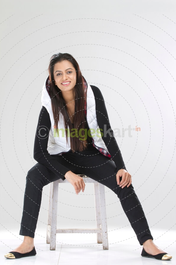 joyful pretty female sitting on a stool
