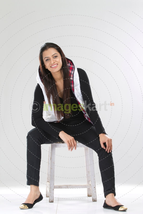 joyful pretty female sitting on a stool