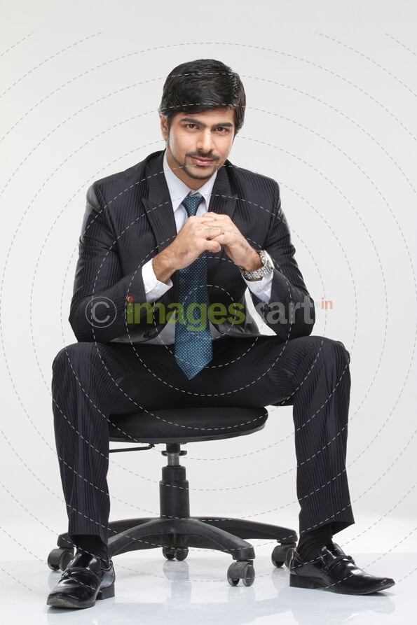 young male employee posing in suit 