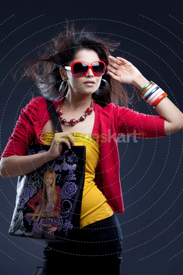 stylish young female carrying handbag and posing 