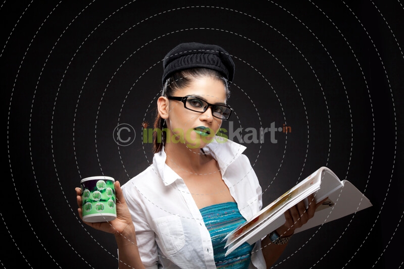 girl wearing green lipstick posing with magazine and coffee cup