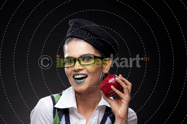 girl in a trendy make-up holding a red apple