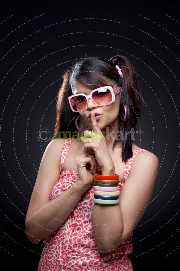 girl in casual wear telling to keep quiet
