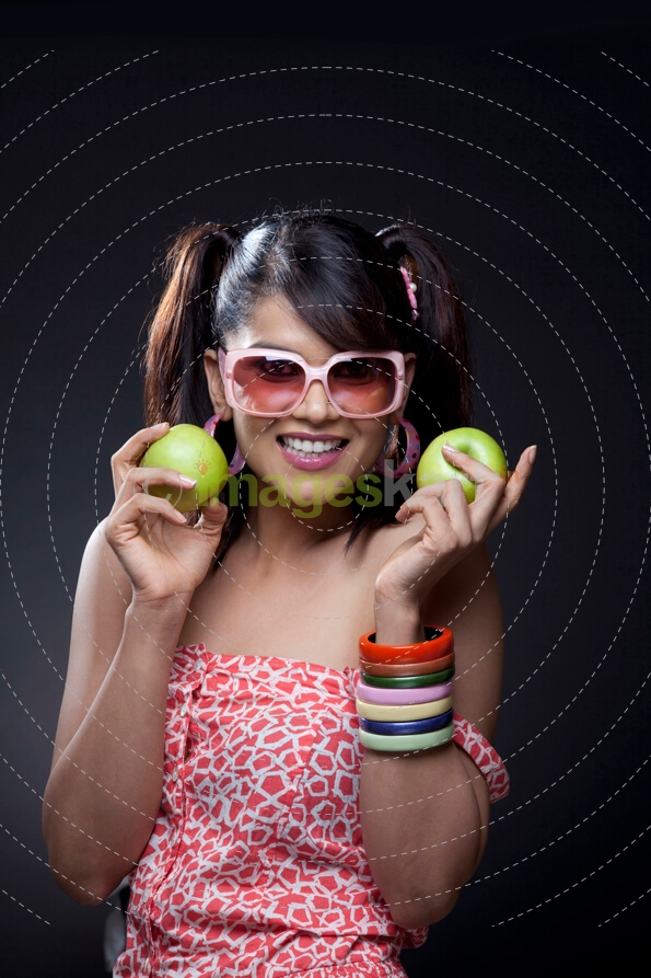girl posing with green apples