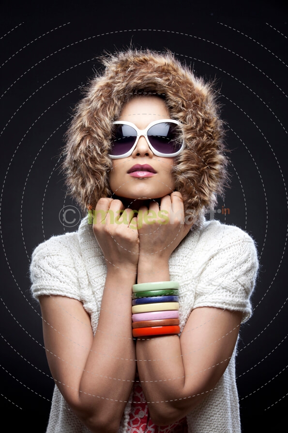 young girl in sunglasses and a fur hood