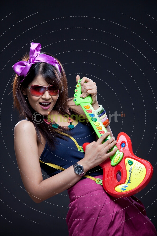 young woman with a toy guitar