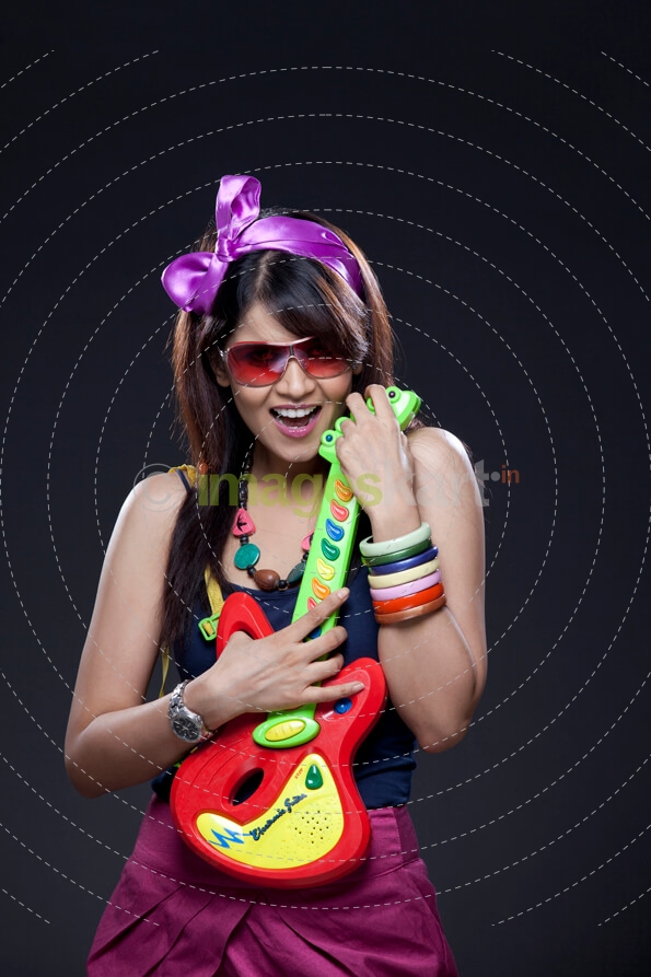 teenager in party wear with a guitar