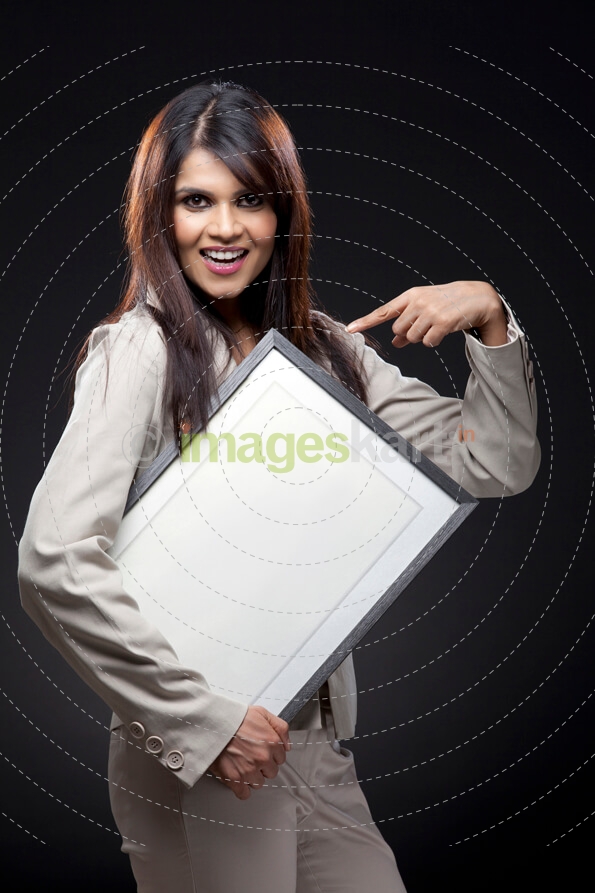 woman pointing at the blank photo frame