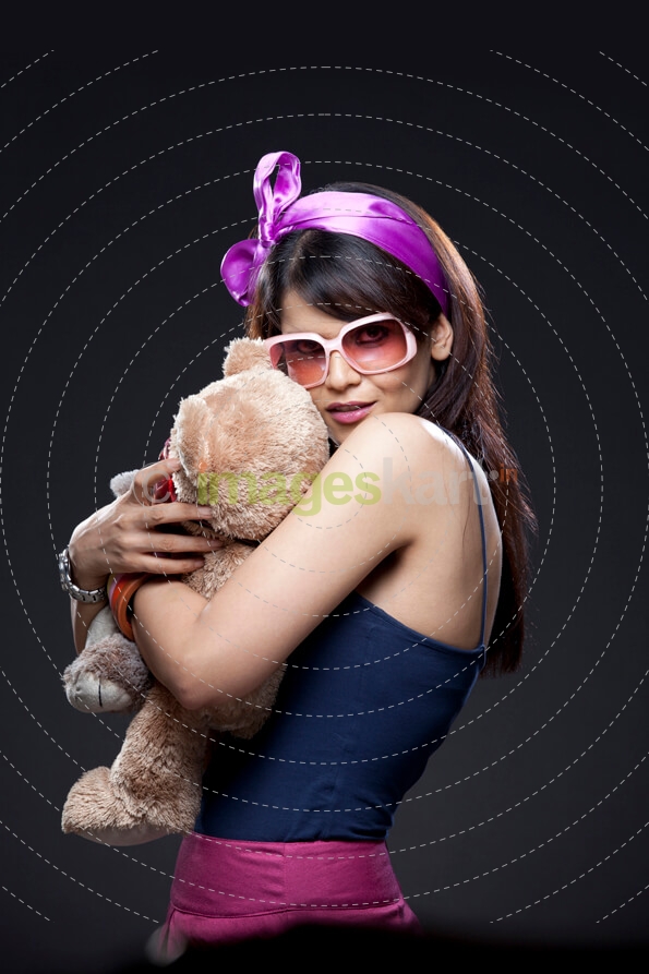teenager hugging a teddy bear