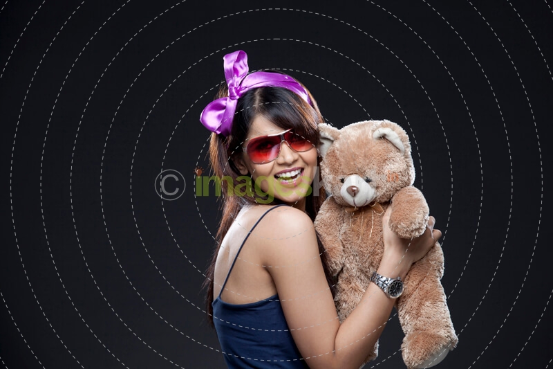 smiling young woman with her teddy bear