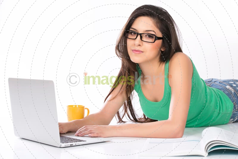 girl lying and posing with a silver laptop
