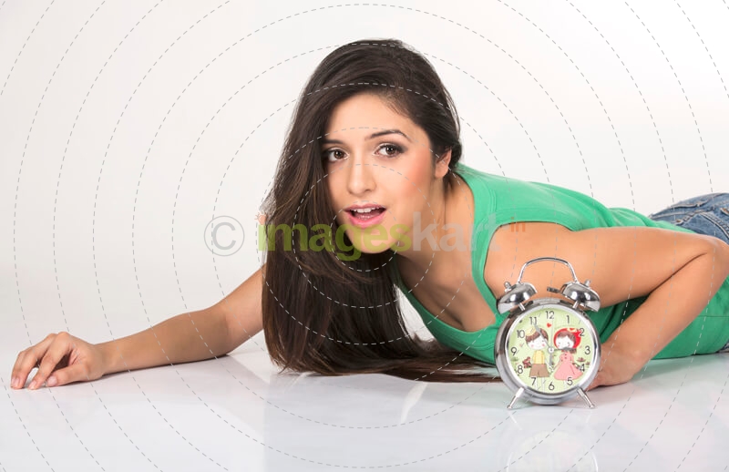 young girl posing with alarm clock