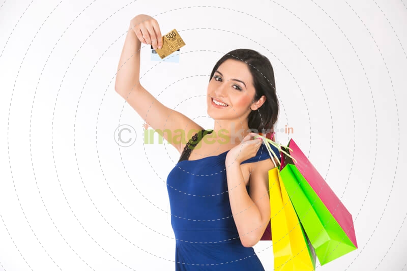 young woman with shopping bags and a credit card