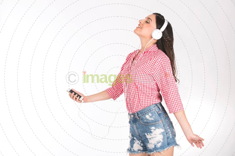 girl in check red shirt enjoying music