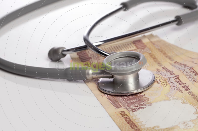 close up shot of stethoscope and cash 