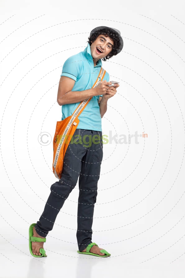 portrait of a boy texting on the mobile phone