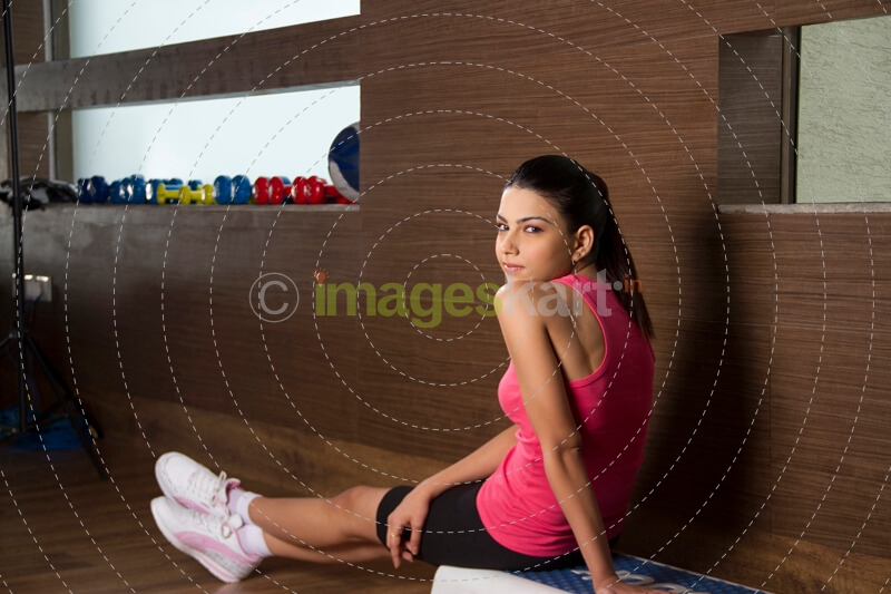 girl looking back while sitting on a stool 