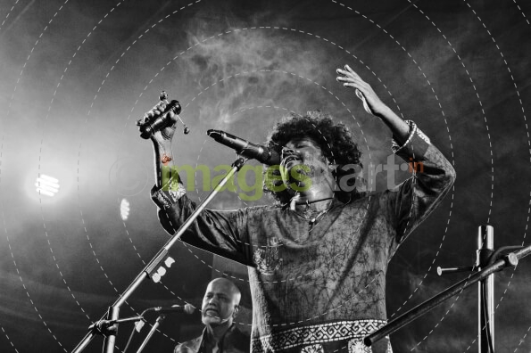 singer singing on stage at night