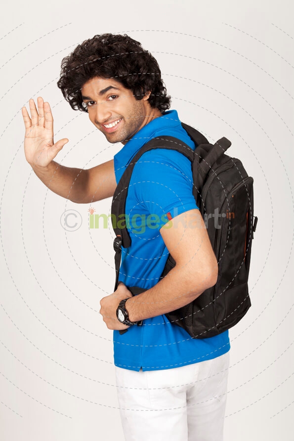 college boy waving hand while smiling