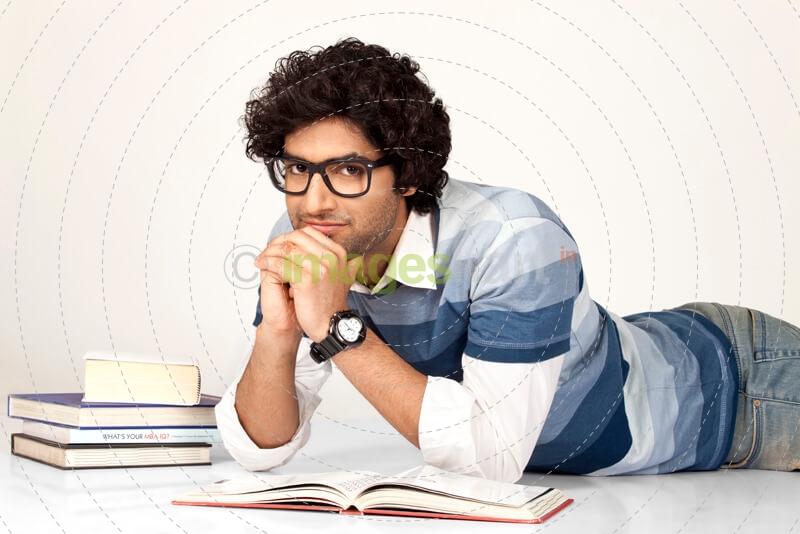 college boy studying and posing for the camera 