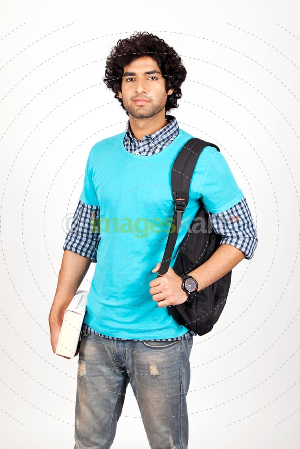 college boy carrying bag and holding book