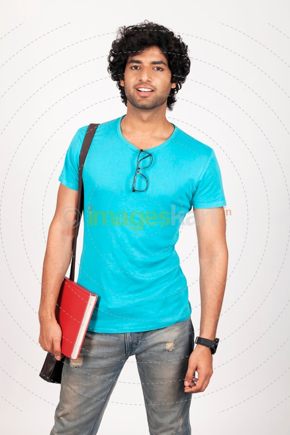 college guy holding a book and posing 
