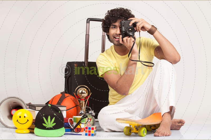 boy sitting and clicking with camera  