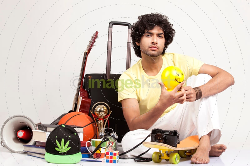 boy holding a ball while posing